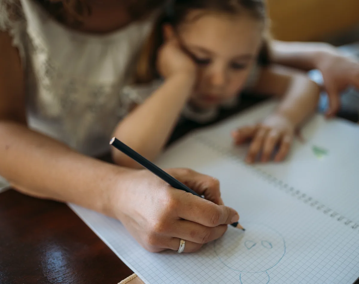 Enfant accompagné dans une activité de dessin